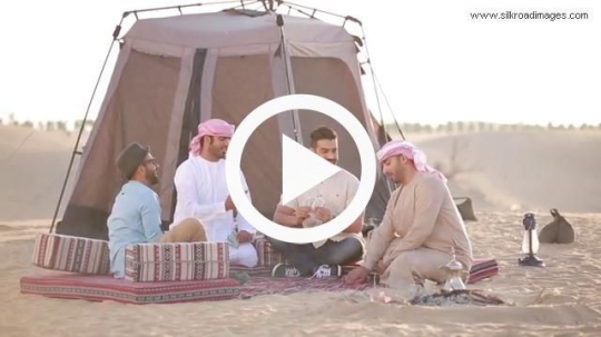 Friends playing cards outside tent
