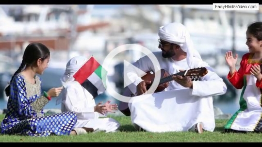 Arab family sitting on the grass celebrating the UAE National Day|