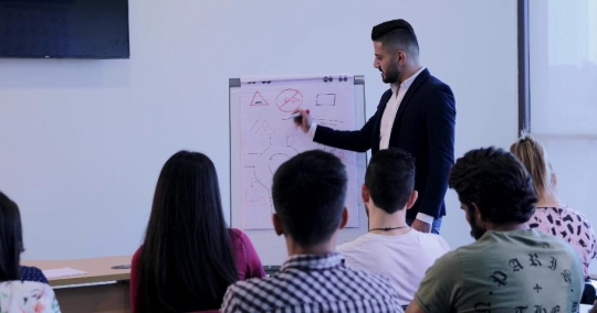 Middle Eastern Professor teaching his students in class|-