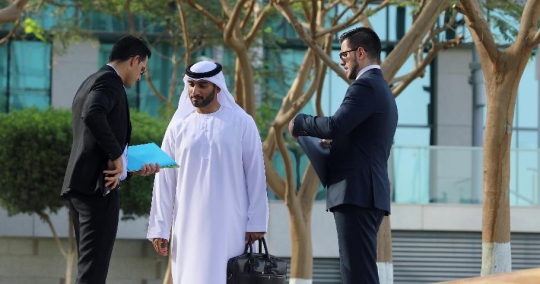 Middle Eastern Businessmen walking towards his colleagues |-