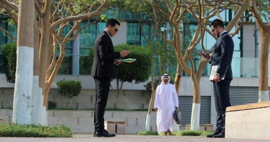Businessmen standing using their mobile |-