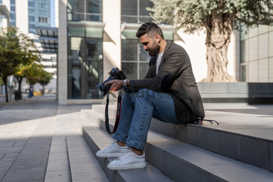 Close-Up of a Cheerful Photographer on Steps in Amman Boulevard