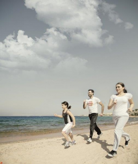 Family Running by the Sea 
