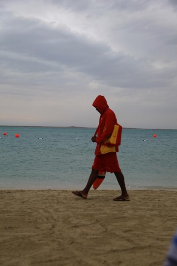 man walking by the beach