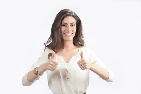 Cheerful woman making thumbs up
