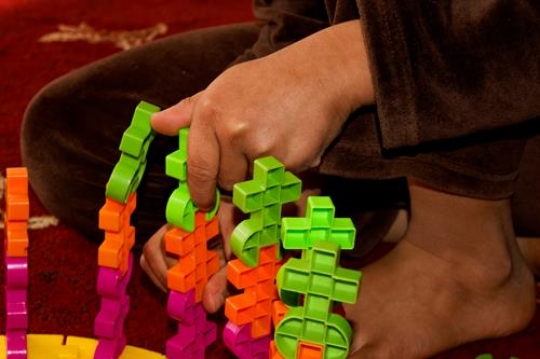 child play with plastic toy blocks