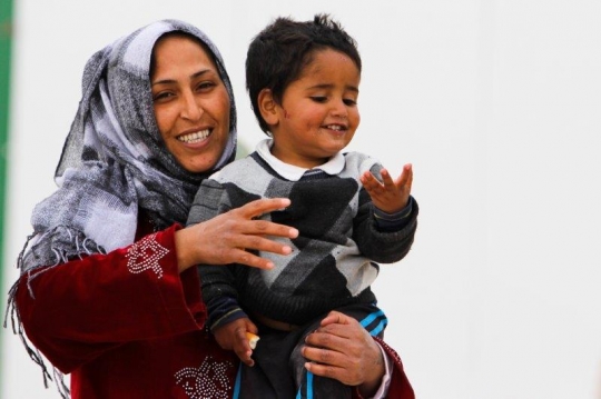 Women with her son from Zaatari refugee camp for Syrian refugees