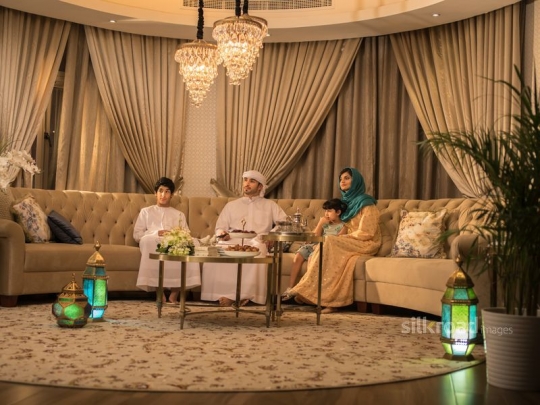 Family sitting in living room|-