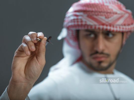 Man aiming with pin at target 