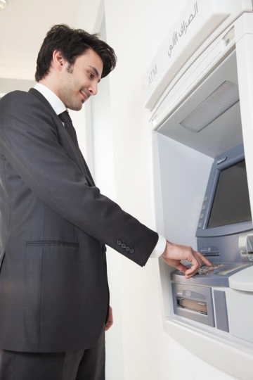 man at automatic teller machine