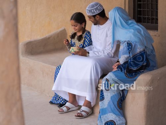 Child taking dates from father|-