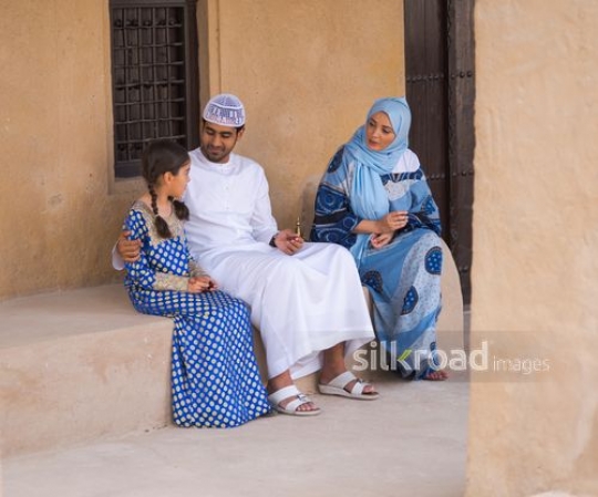 Girl enjoying time with parents outside|-