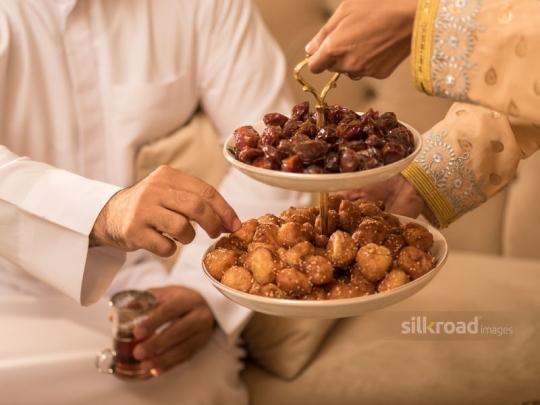 Serving Arabic sweets|-