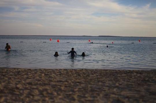 kids playing in the water by the beach