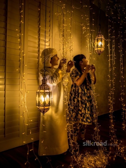 Brother and sister enjoying ramadan ornaments|-