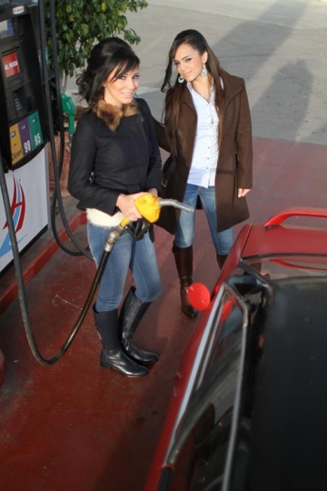 woman holding fuel nozzle in g