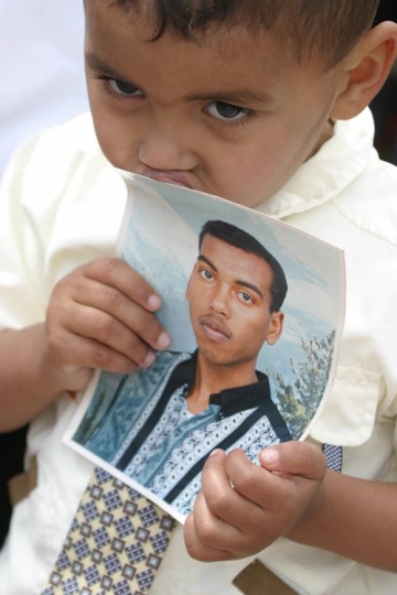 young boy holds a picture