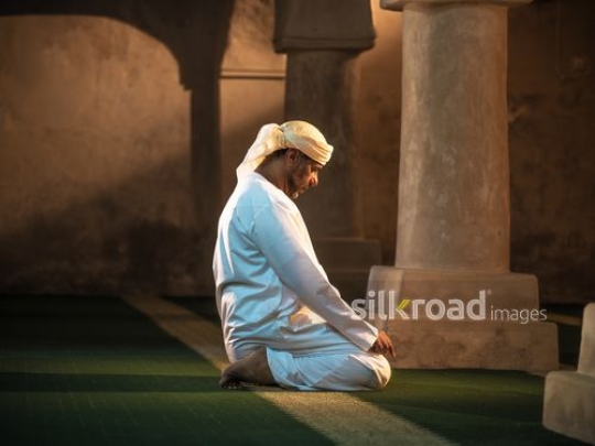 Old man praying on the floor|-