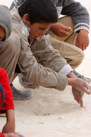 Boys playing glass balls from Zaatari refugee camp for Syrian refugees