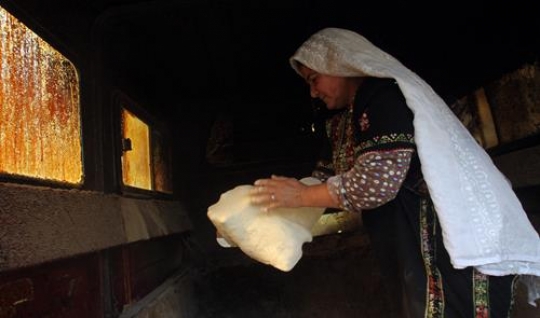 Palestinian woman baking bread