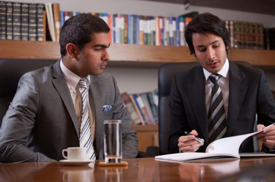 Young Executive Going Over Report with Employee