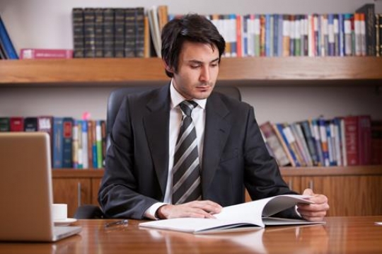 Young Male Executive Going Over Report