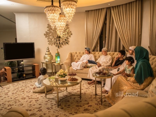 Family gathered in TV room|-