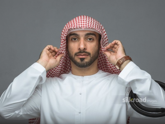 Arabian man fitting his head cover