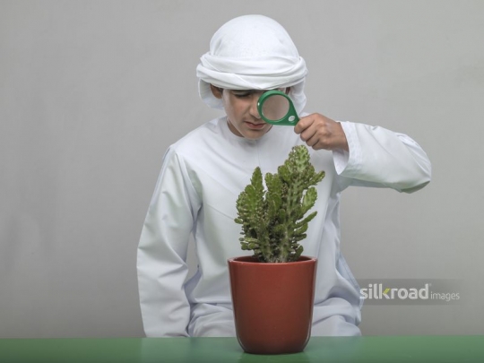 Little boy experimenting with his magnifier