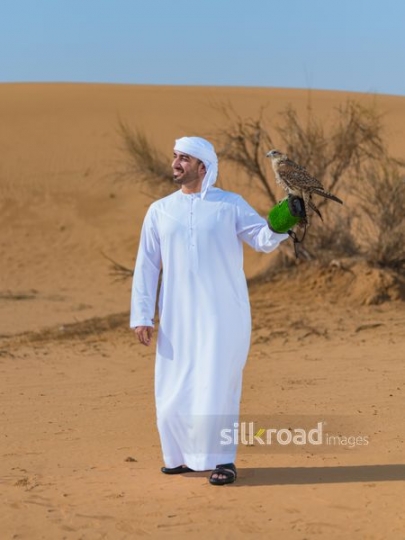Man lifting up falcon