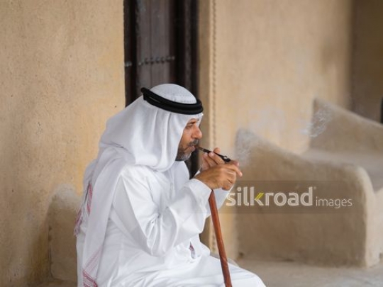 Oldman smoking outside|-