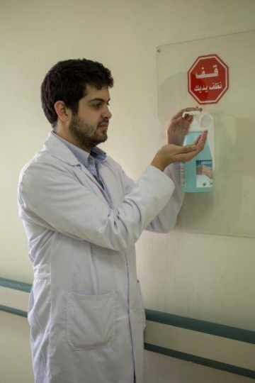 Doctor Sanitising his Hands