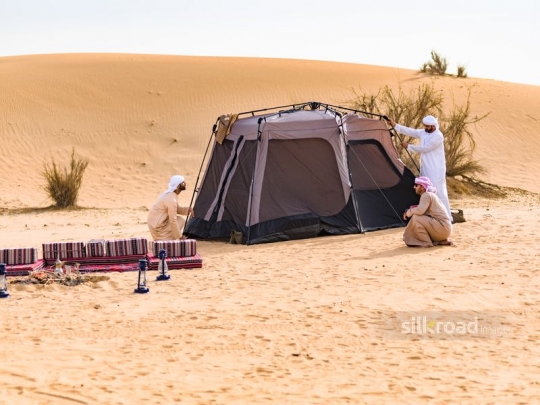 Men mounting up the tent
