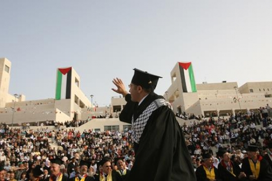 young graduate student waving 