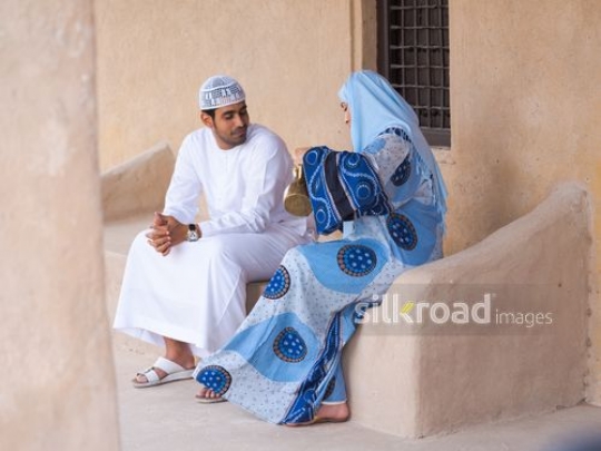 Wife serving coffee to husband|-