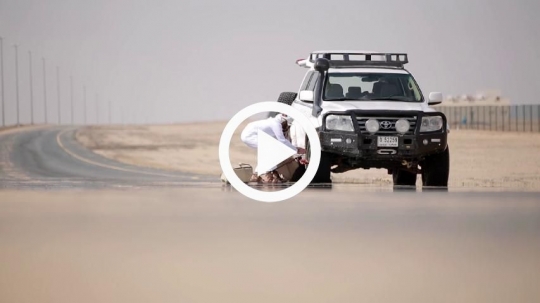 Men fixing flat tire