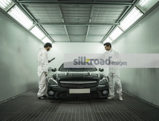 Mechanics checking car at the workshop|