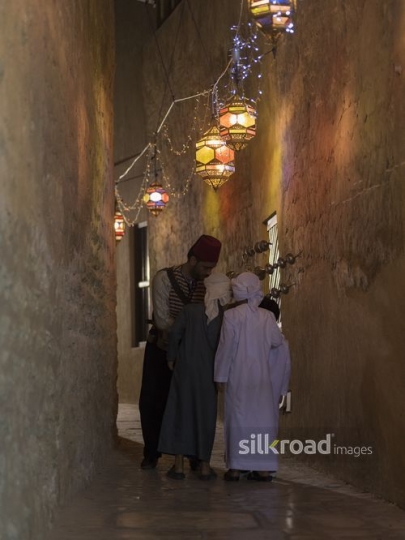 Middle Eastern Ramadan drink seller offering the kids some juice|-