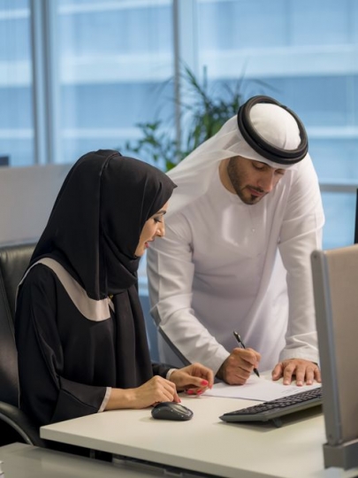 Business man and woman sitting by the desk working together|