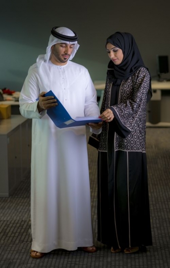 Two arab employees checking business file|-