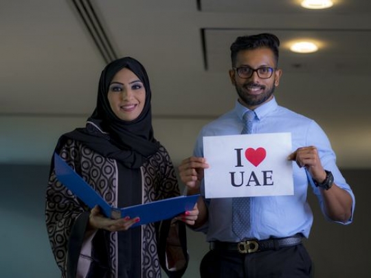 Mid-shot of a businessman and a business woman celebrating National Day|-