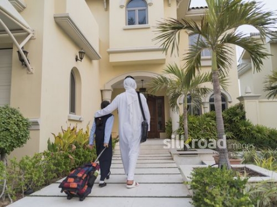 Middle Eastern father and daughter walking to the house|