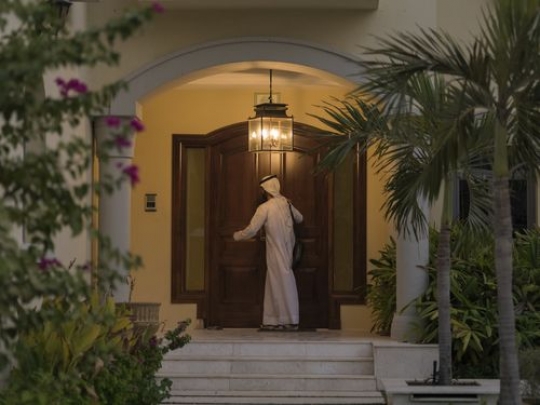 Arab man exiting his house|-