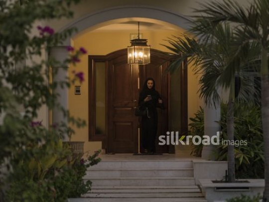 Middle Eastern woman leaving the house|