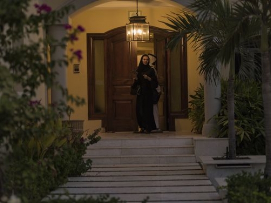 Arab woman and man leaving the house|-