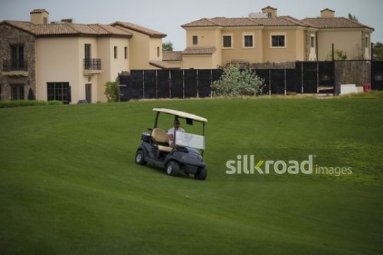 Middle Eastern man driving the Golf Cart|-