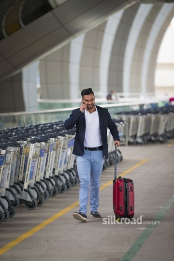 Middle Eastern man talking on the phone|-