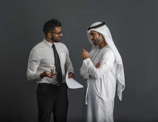 Business men standing and talking to each other|
