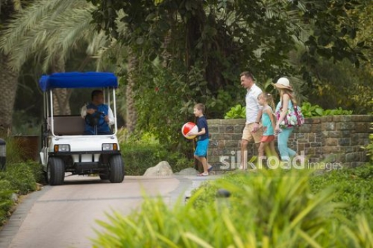 Western Family walking towards the golf cart|-