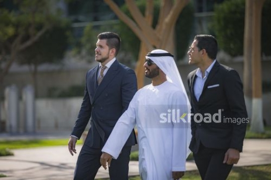 Three successful Businessmen walking together|-